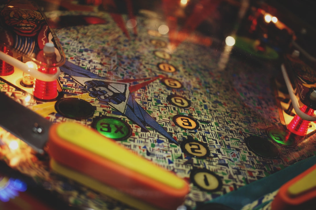 a close up of a pinball machine with a lit candle