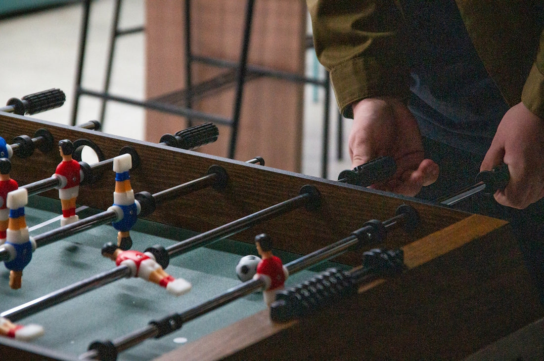 A man is playing a game of foo - pong
