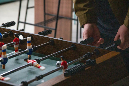 A man is playing a game of foo - pong
