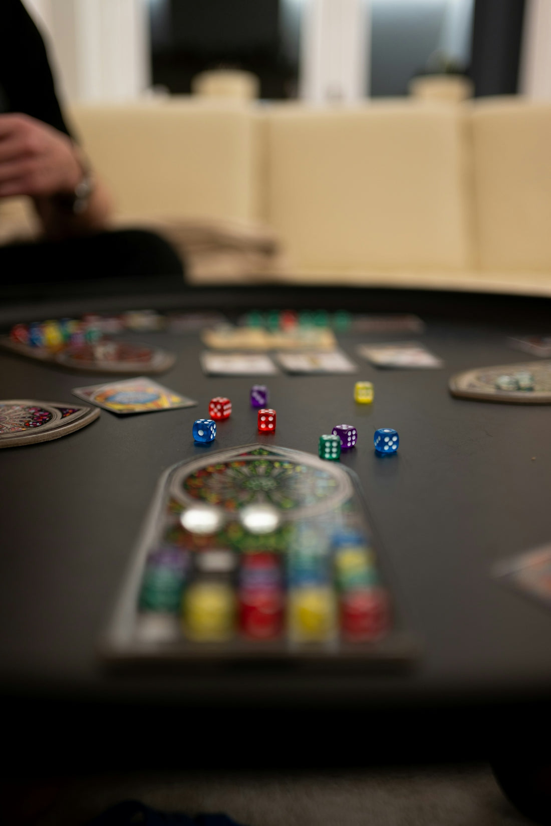 A black table topped with lots of dice