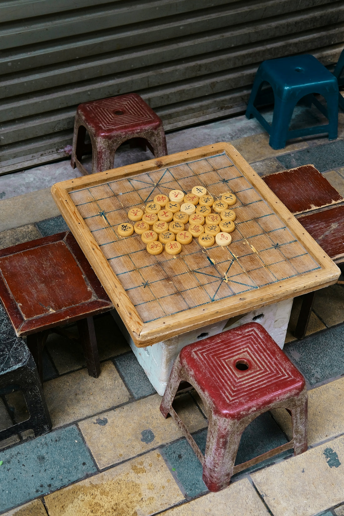 A chinese chess board with pieces on a table.