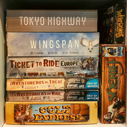 Stack of board games on a shelf